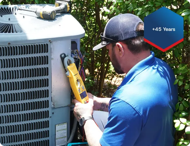 AC Technician Servicing Outdoor AC Unit At Southwest Florida